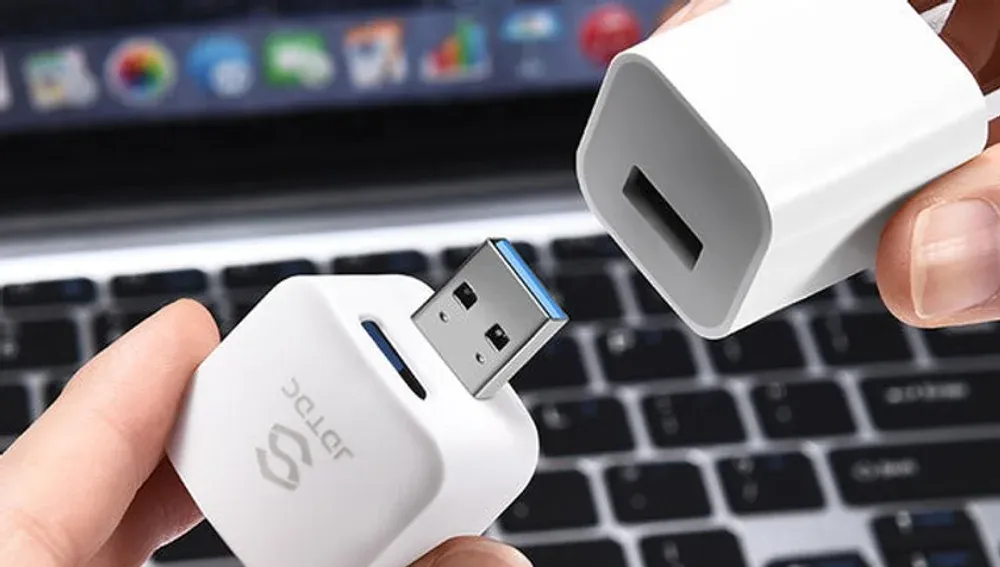 Auto Backup Cube device backing up a phone